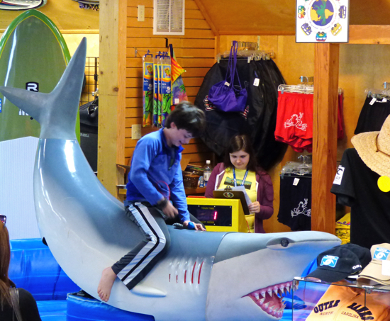 Riding the mechanical shark at Kitty Hawk Surf Company in Nags Head.