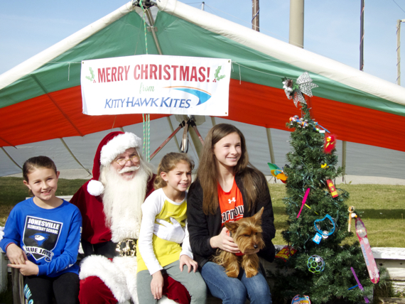 Santa Claus greeting a family at Kitty Hawk Kites.