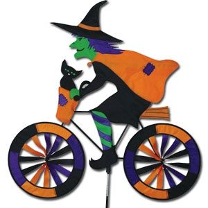 A wind spinner that looks like a witch on a bike