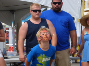 Face painted and competing in last year's watermelon seed spitting contest.