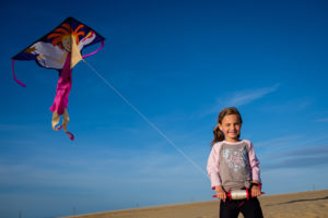 girl flying a delta kite