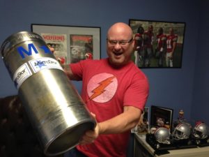A man holding a keg that will soon earn its wings at the annual Kitty Hawk Kites Brewtag