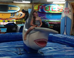 a girl riding a mechanical shark