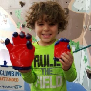 A boy proud to hold up his wax hands