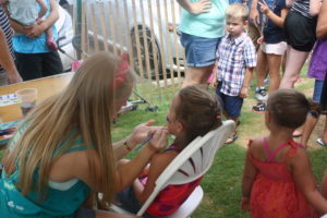 A girl getting her face painted at the Watermelon Festival