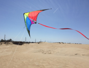 A bright colored stunt kite flying