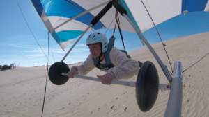 A hang glider gliding down the dunes of the Outer Banks