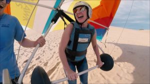 A woman hang glider with a big smile