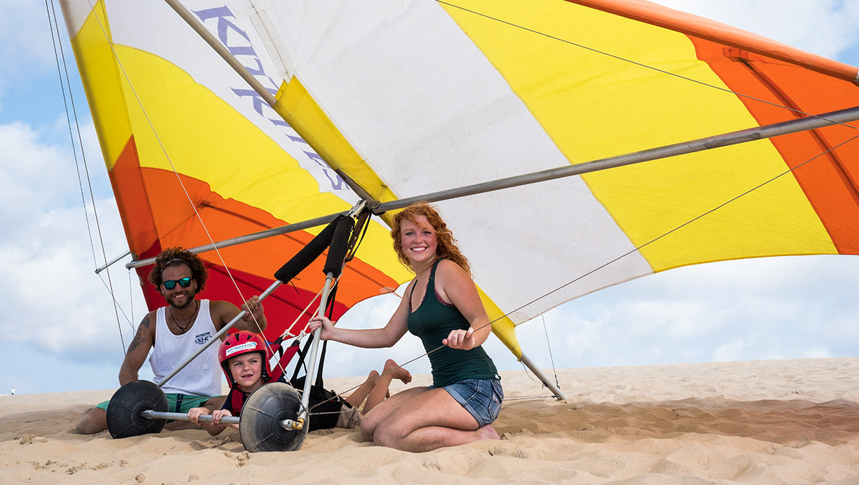 A kid smiling during hang gliding lessons