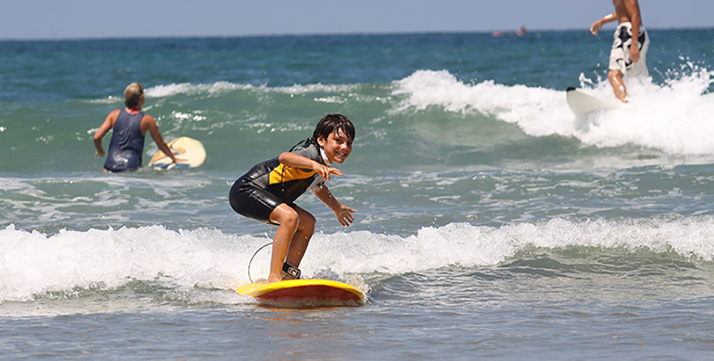 kid surfing in the ocean