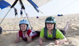 Two kids ready for their hang gliding lesson