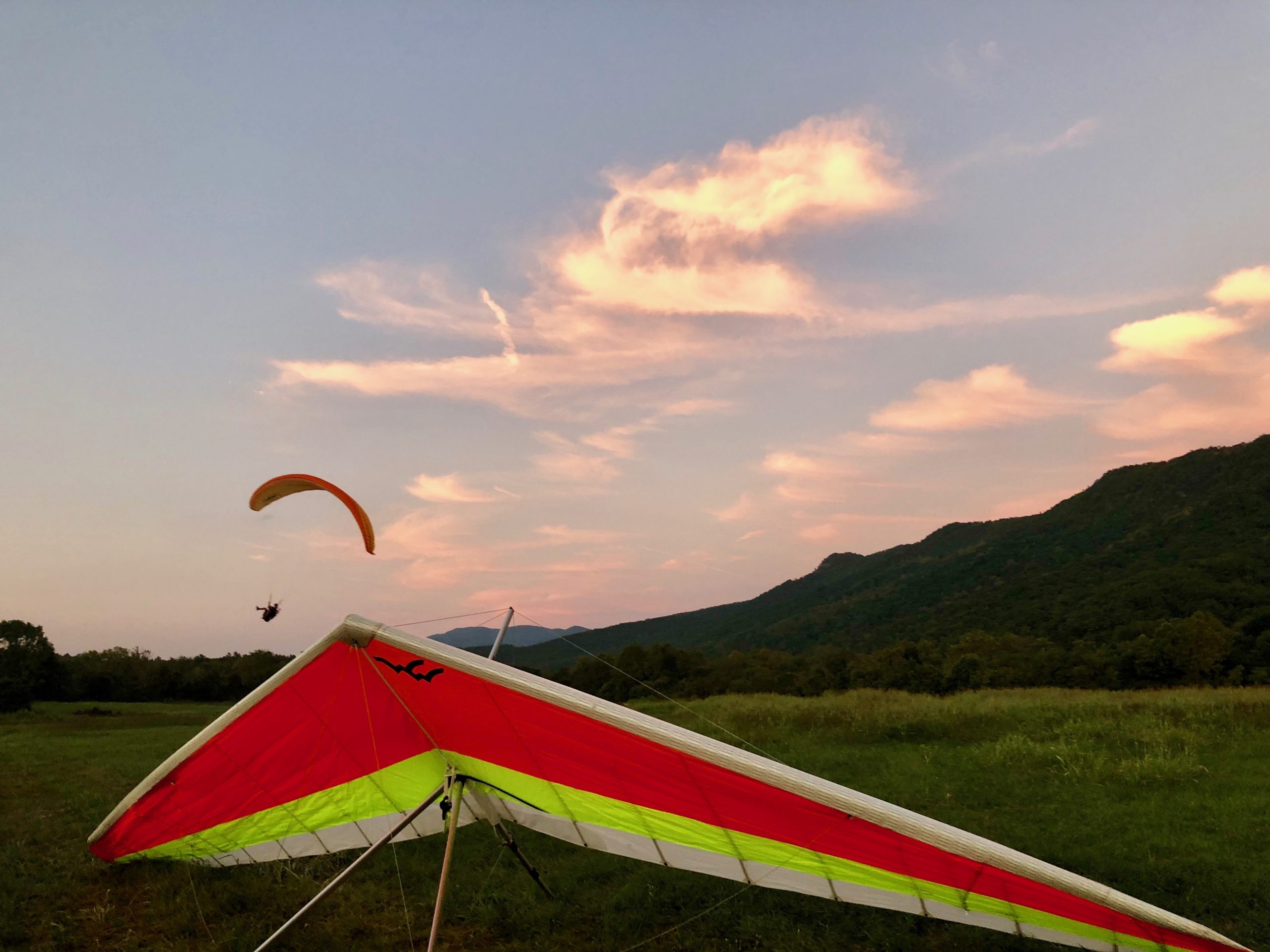 hang glider and paraglider at sunset