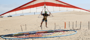 Joe Bedinghaus landing in the bullseye at the dune hang gliding competition