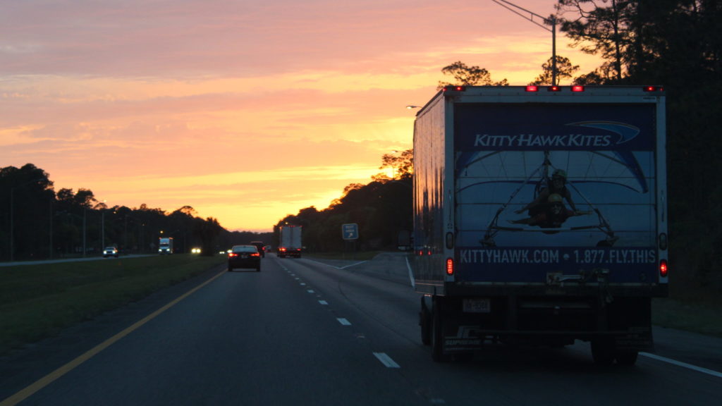 Kitty Hawk Kites box truck driving at sunset to the Florida Fly Into Spring Kite Festival