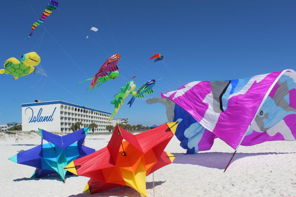 Multiple kites flying on the beach at the 2022 Fly Into Spring Kite Festival