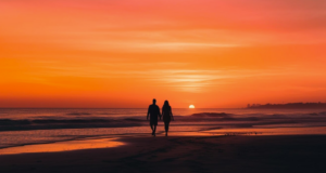 A couple walks the beaches of the Outer Banks at sunset