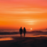 A couple walks the beaches of the Outer Banks at sunset