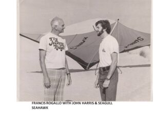 John Harris and Francis Rogallo in front of hang gliders on Jockey's Ridge